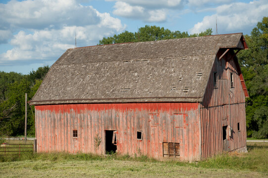 Abandoned barn with weathered facade and faded red paint, near Dunbar, Nebraska, USA; Dunbar, Nebraska, United States of America