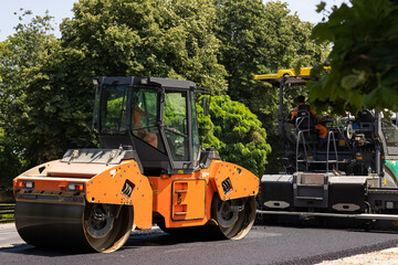 Compactor roller during road construction at asphalting work