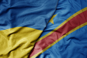 big waving national colorful flag of ukraine and national flag of democratic republic of the congo .