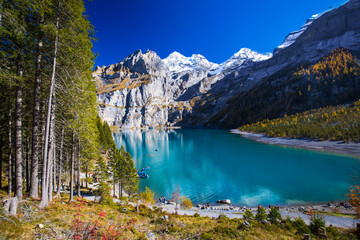 Amazing tourquise Oeschinnensee with waterfalls, wooden chalet and Swiss Alps, Berner Oberland,...