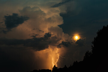 Naklejka na ściany i meble Lightning strike and moon with storm clouds at night