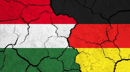 Flags of Hungary and Germany on cracked surface - politics, relationship concept