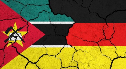 Flags of Mozambique and Germany on cracked surface - politics, relationship concept