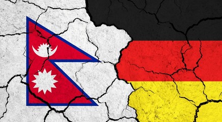 Flags of Nepal and Germany on cracked surface - politics, relationship concept