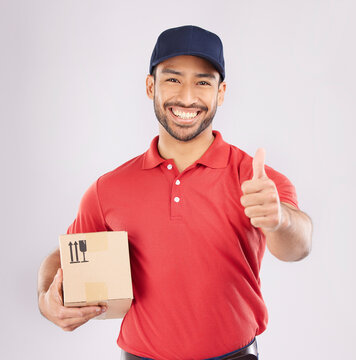 Courier Man, Thumbs Up And Studio Portrait With Box, Delivery Company And Smile By White Background. Supply Chain Manager, Happy And Review With Icon, Emoji Or Sign Language With Cardboard Package