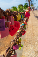 Love lockers hanging on chain at Playa Grande, large beach at Puerto del Carmen, Lanzarote, Canary Islands, Spain