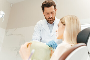Fototapeta premium Professional dentist preparing patient woman to checking teeth