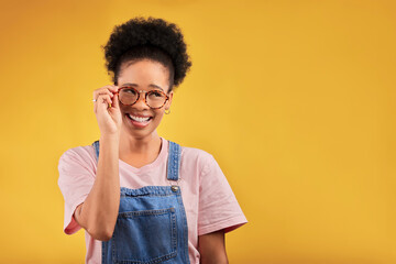 Smile, glasses and vision with a black woman nerd on a yellow background in studio for style....