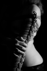 Girl's hand tied with a shibari rope.
