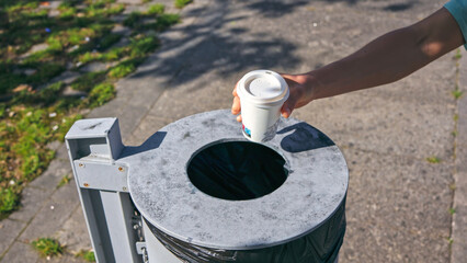 Taking a Stand: Person Discarding Garbage, Promoting Recycling and Clean Environment