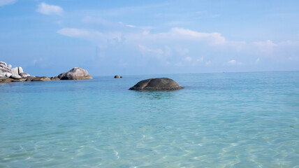 Landscape of large stones on the surface of belitung beach with a view of the clear blue sky. Vacation time and relax with your beloved family
