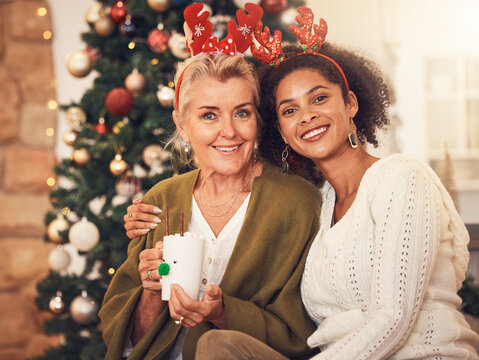 Portrait, christmas and blended family with a woman and daughter in law together in a home during the festive season. Smile, love and diversity with happy people in a house for december celebration