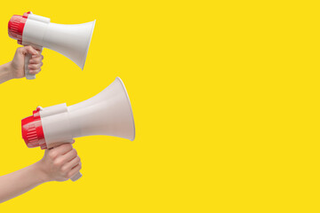 Megaphone in woman hands on a white background.