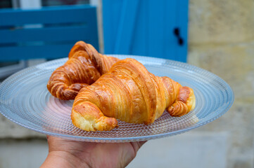 Two fresh baked puff croissants, traditional French breakfast
