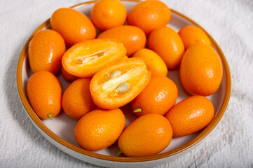 Delicious small citrus fruits orange kumquats close up
