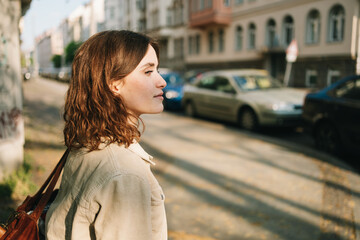 Thoughtful Young Woman in an Urban Scene, Looking to the Side