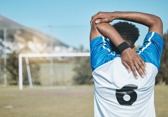 Man, soccer and stretching arm in fitness commitment for match, game or training on grass field...