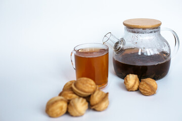 Teapot with cookies on white background