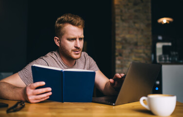 Concentrated man studying on laptop