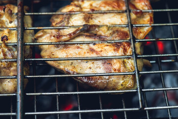 Chicken meat grilling on the brazier. Selective focus.
