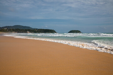 Fototapeta na wymiar Beautiful beach on a summer day. Blue sky. Sunny day. Yellow sand on the beach.