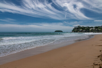 Fototapeta na wymiar Beautiful beach on a summer day. Blue sky. Sunny day. Yellow sand on the beach.