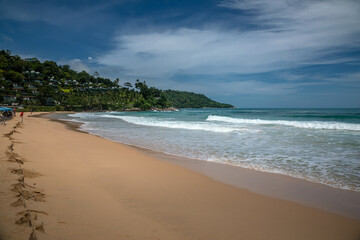 Beautiful beach on a summer day. Blue sky. Sunny day. Yellow sand on the beach.