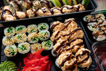 Many different sushi rolls on the table. Delicious Japanese lunch