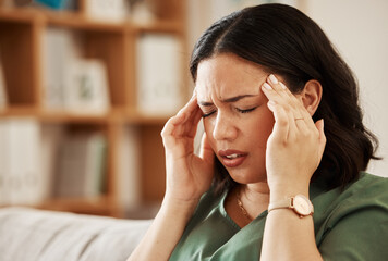 Stress, headache and woman on a sofa with vertigo, brain fog or burnout in her home. Migraine,...