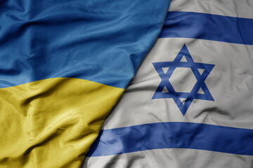 big waving national colorful flag of ukraine and national flag of israel .