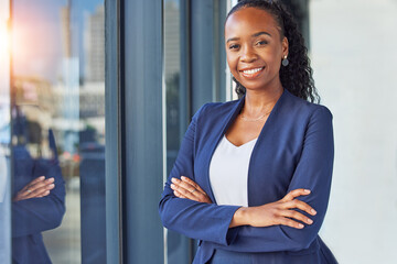 Portrait, window and arms crossed with a business woman standing in her professional office. Smile,...