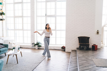 Young woman talking on mobile phone and gesticulating