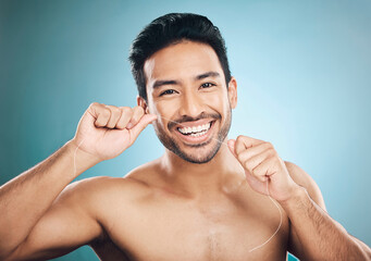 Wellness, teeth and dental floss of a man portrait with cleaning and dental health in a studio....