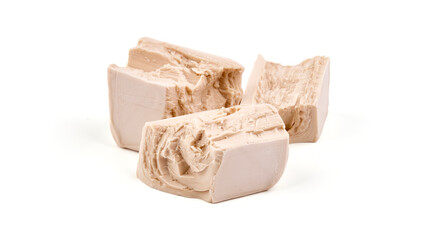 Fresh yeast cube, isolated on white background.
