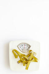 White floor weight scales with measuring tape. Body weight control and slimming concept