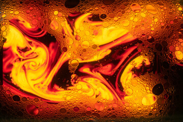 Oil and soap bubbles on water, abstract background.