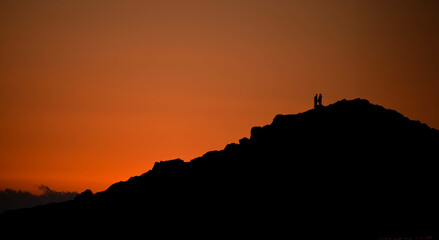 sunset over the mountain with the couple 