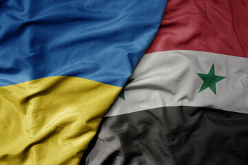 big waving national colorful flag of ukraine and national flag of syria .