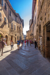 San Gimignano, Italy. Tourists on the street of the old town
