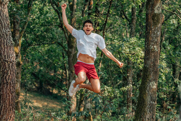 young sportsman jumping with enthusiasm outdoors