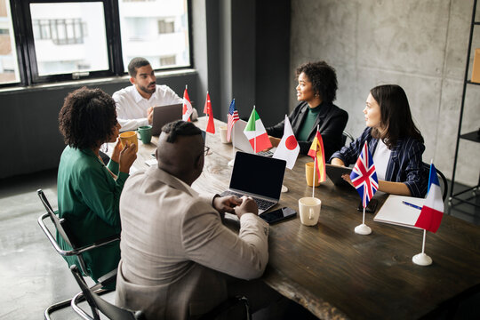 Multicultural Coworkers Businessmen And Businesswomen Sitting In Modern Office