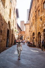 Beautiful female model on the old city streets of San Gimignano, Tuscany, Italy