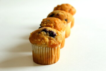  Delicious chocolate blueberry Vanilla muffins in wax liner paper cups isolated on white background,homemade biscuit cakes,Copy space for text