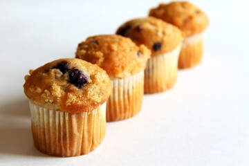  Delicious chocolate blueberry Vanilla muffins in wax liner paper cups isolated on white background,homemade biscuit cakes,Copy space for text