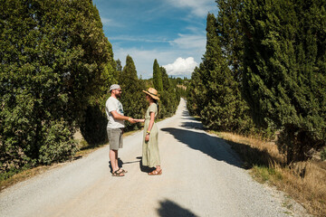 Beautiful traveler couple on the famouse roads of Tuscany, Val D'orcia