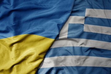 big waving national colorful flag of ukraine and national flag of greece .