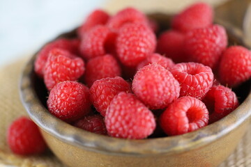 Blueberries in a bowl on wooden table with jute fabric, blueberry in a brown bowl on jute fabric and wooden table