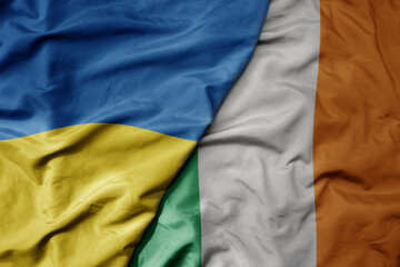 big waving national colorful flag of ukraine and national flag of ireland .