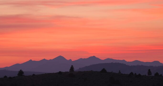 an orange sunset over purple mountains in the Oregon desert