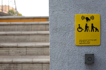 Yellow sign with the sign of a person with a disability in a wheelchair, a person with baby...